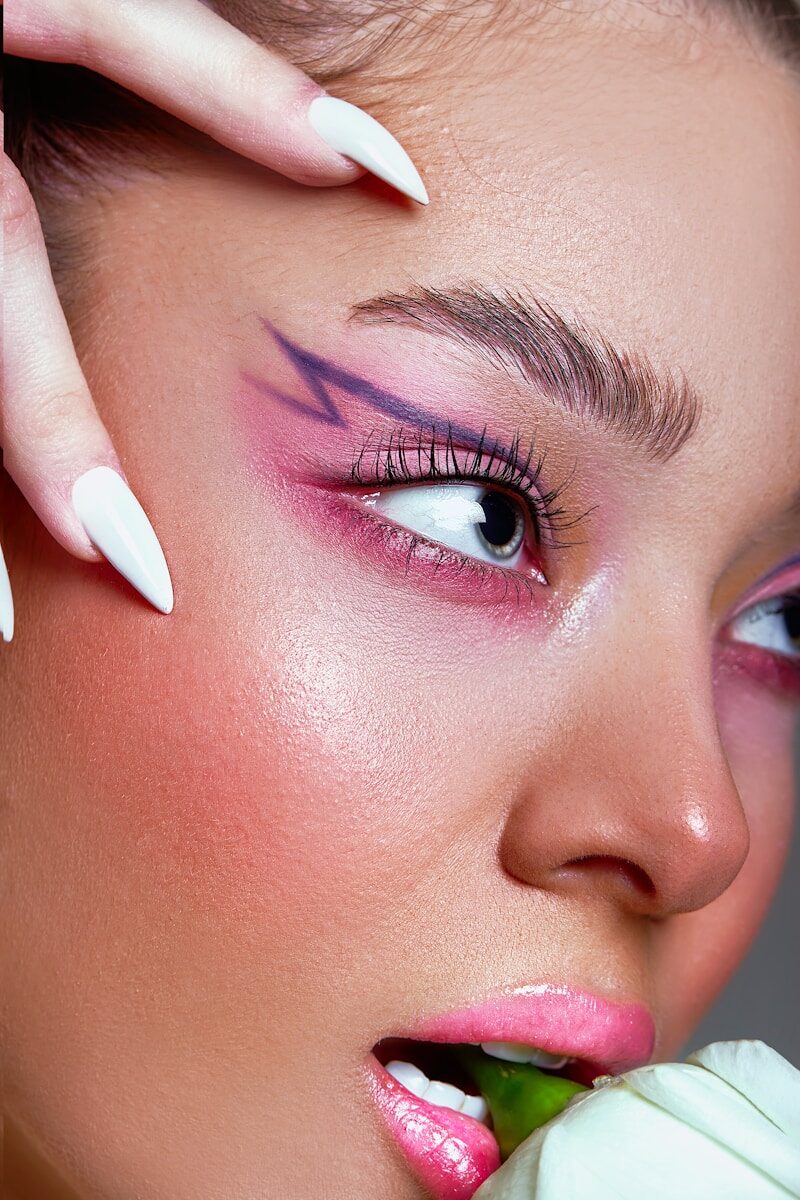 a close up of a person with a flower in their hand