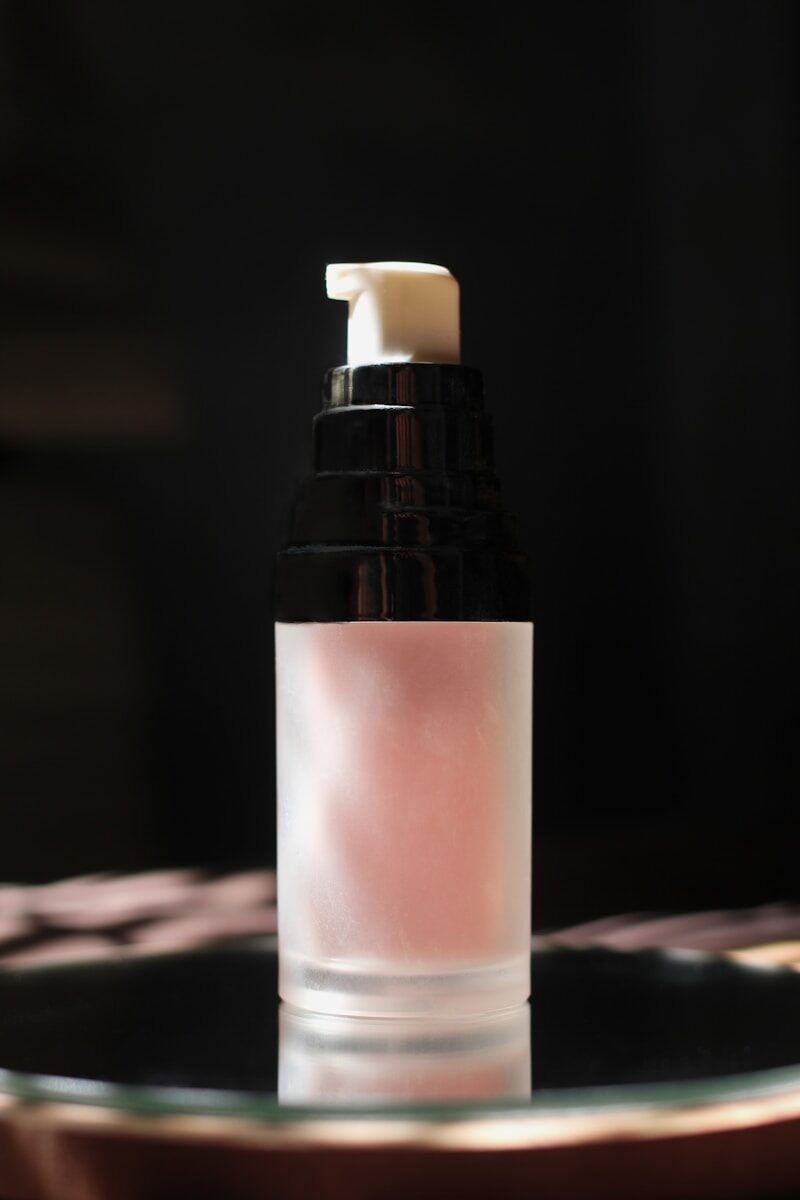 white and black bottle on brown wooden table