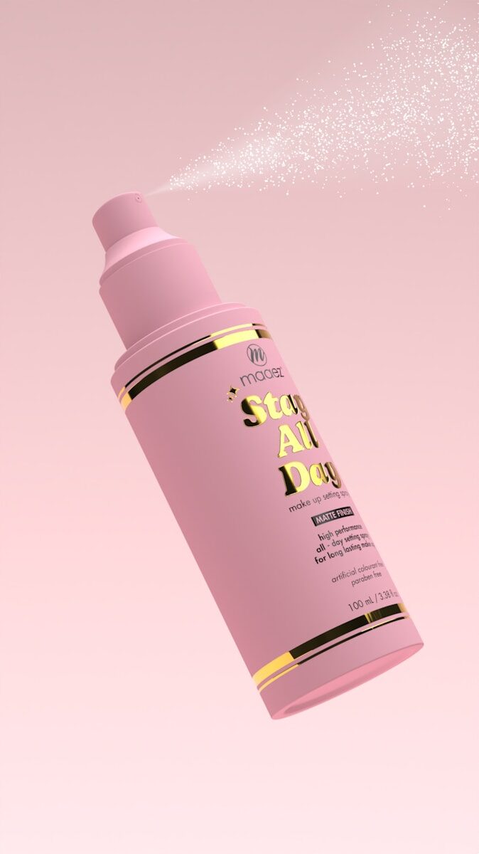 a pink spray bottle flying through the air
